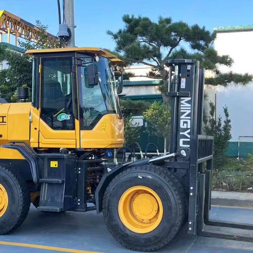 How would a worker driving a rough terrain forklift prevent it from tipping over?